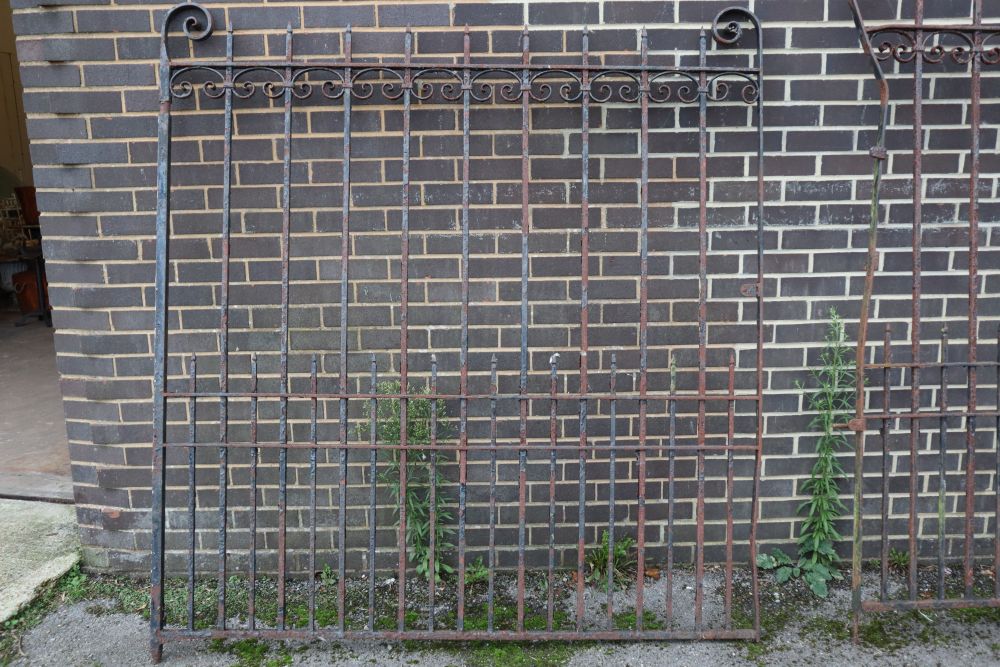 A pair of wrought iron gates, each gate 177cm wide, 193cm high